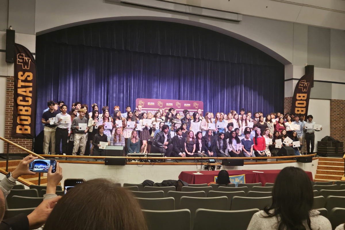 New inductees of the Science National Honors Society stand together for a photo