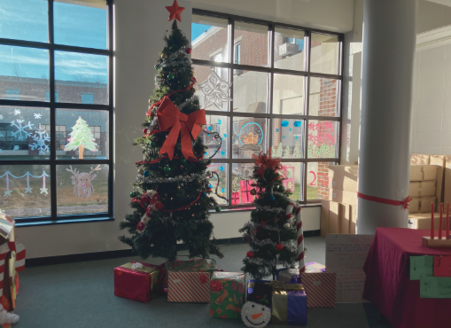 Presents wrapped up under a Christmas tree in a SWHS lobby.