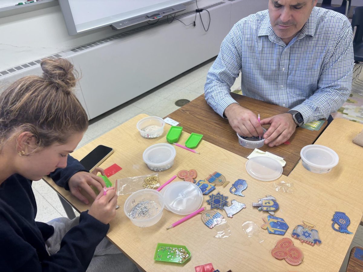 Fiona Downes and Mr. Savvides concentrating on their growing diamond paintings.