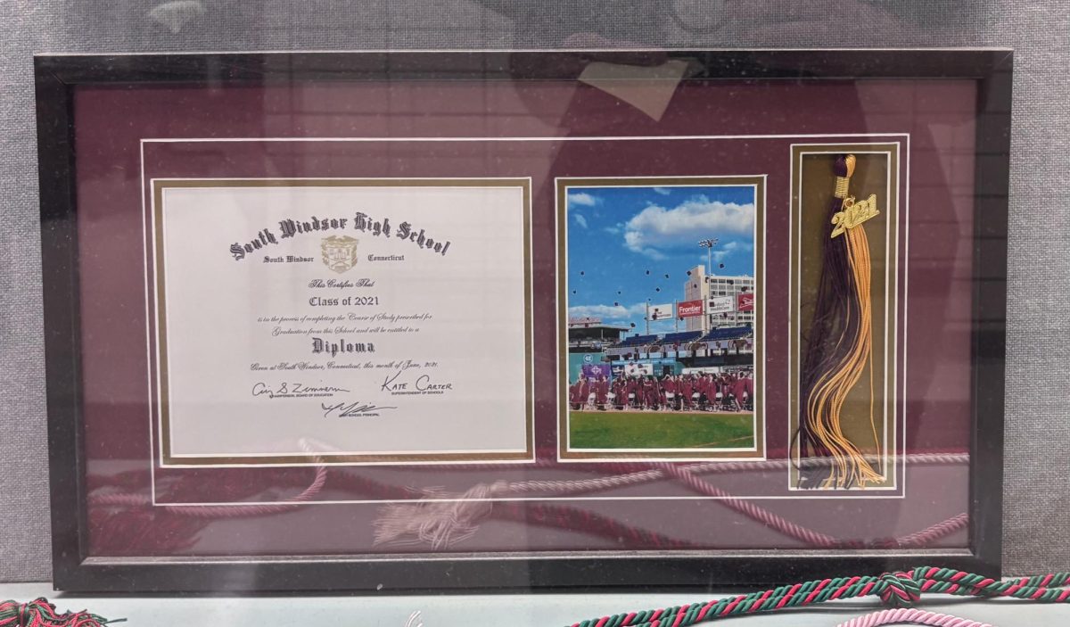 Framed class of 2021 diploma in hallway case from South Windsor High School.