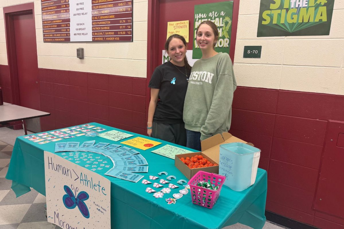 Volunteers at the equity basketball game, promoting its main message to attendees. 
