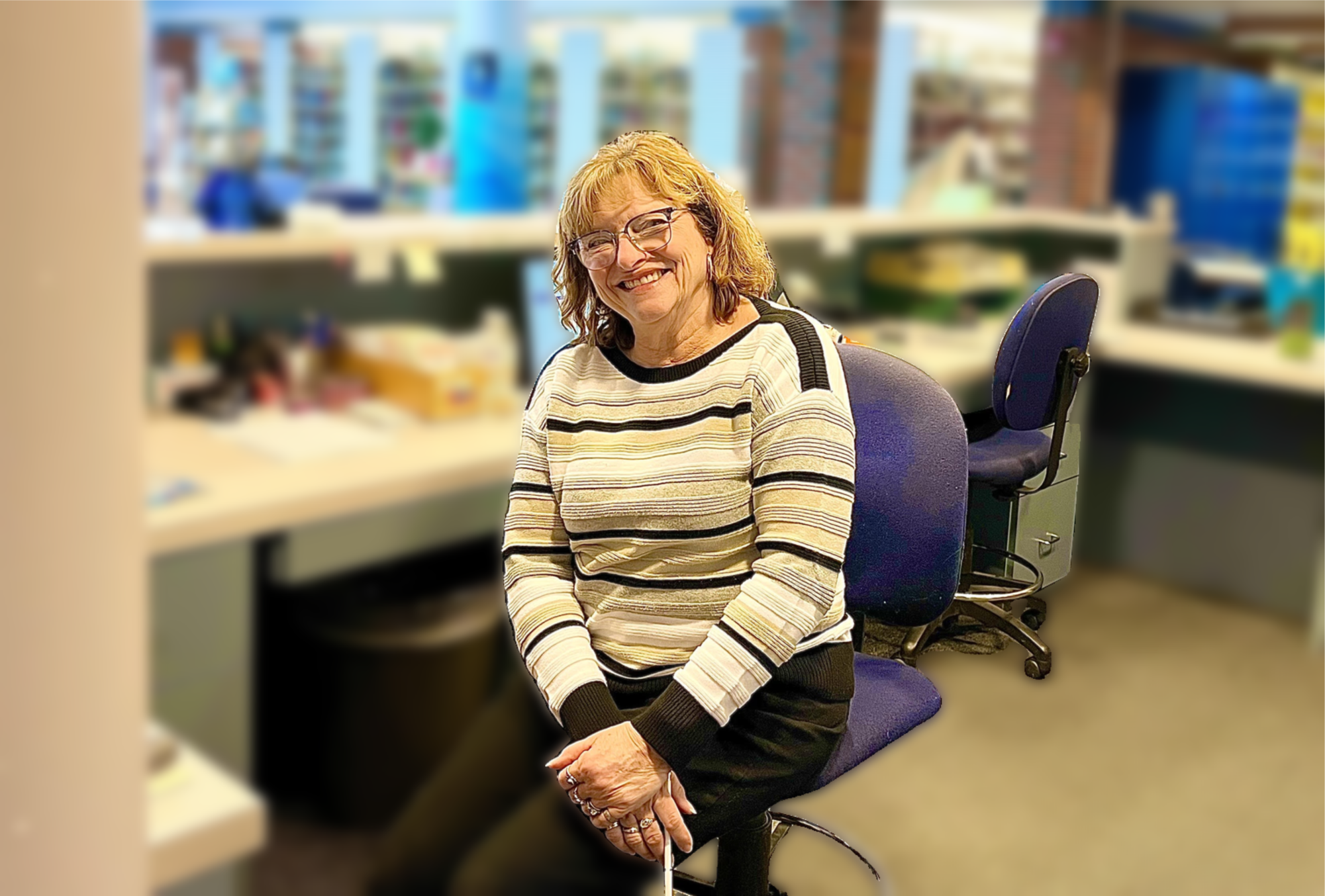 Media aide Joyce Hilton sitting at her desk in the library media center 