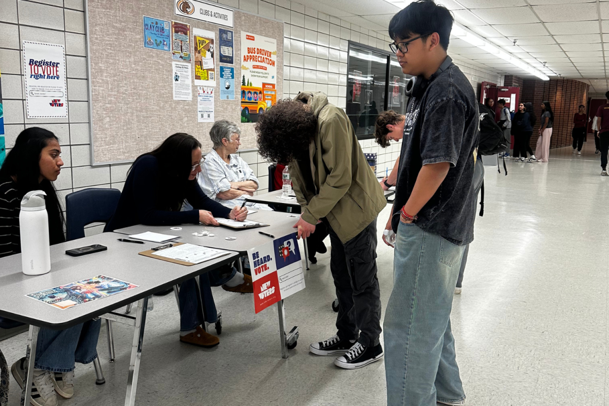 A senior getting help in order register outside of the South Windsor High School cafeteria