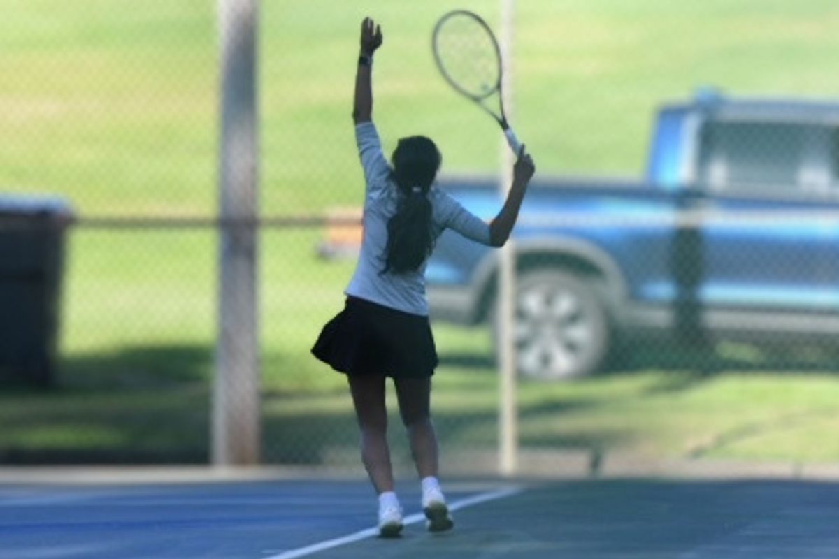 Senior Lavanya Rathore gets in position to serve the ball during a match.(photo courtesy of Mrs. Belval)