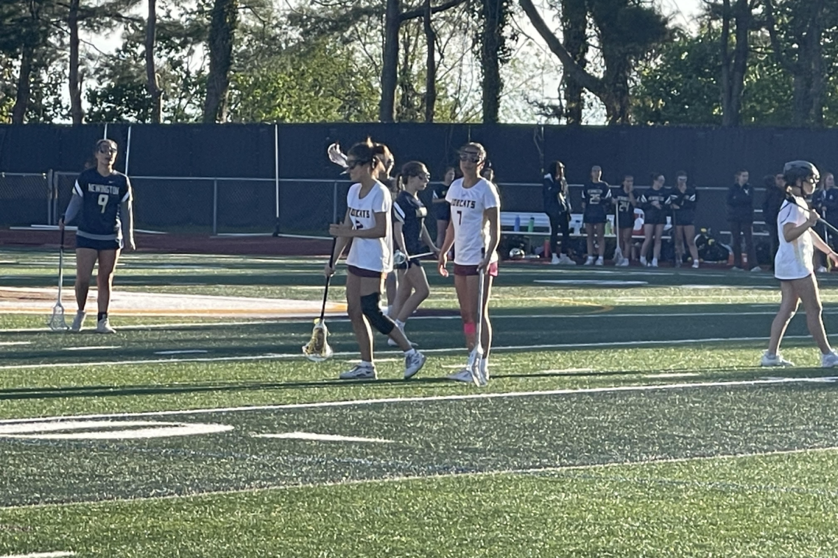 Seniors Fiona Downes and Mimi Hamadi walking towards the circle during their game against Newington. (photo courtesy of Mrs. Quinn)