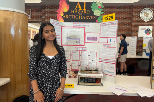 Elina Basu stands in front of her science fair project.