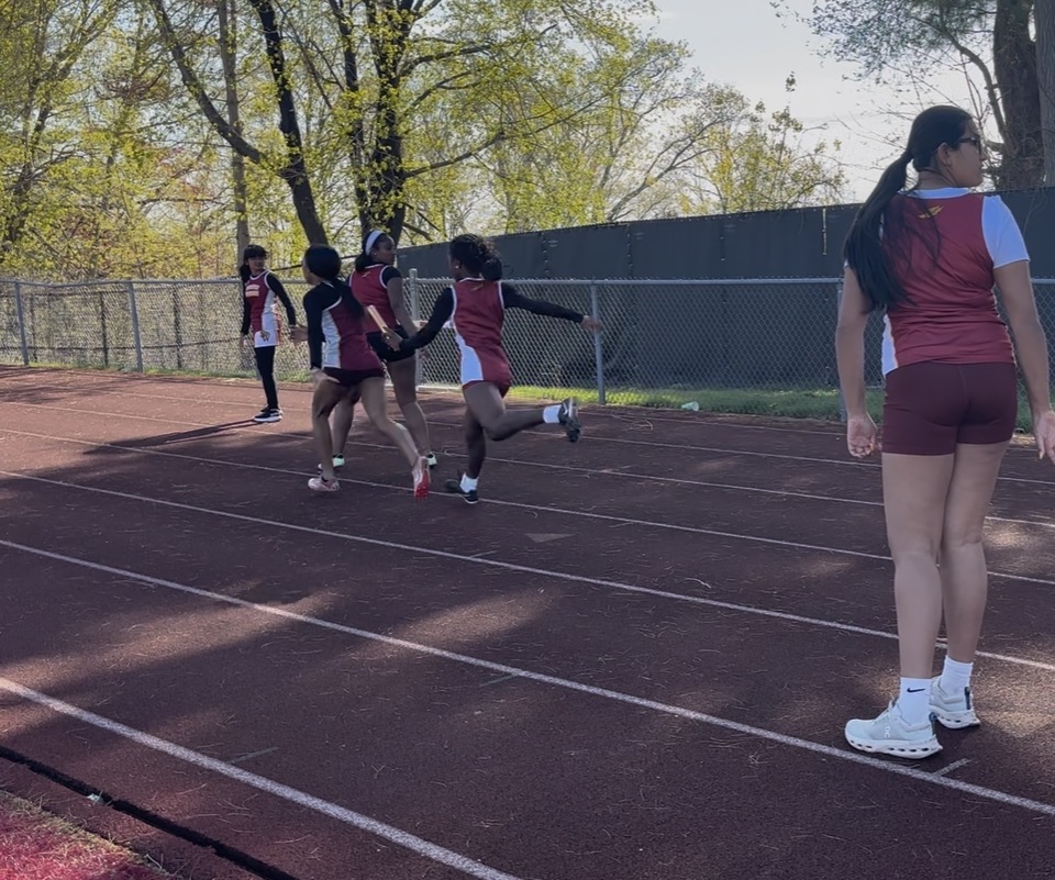 Ava Lilburm handing off the baton to Destiny Gooden in a track meet. (Photo courtesy of Mahima Sasikumar)